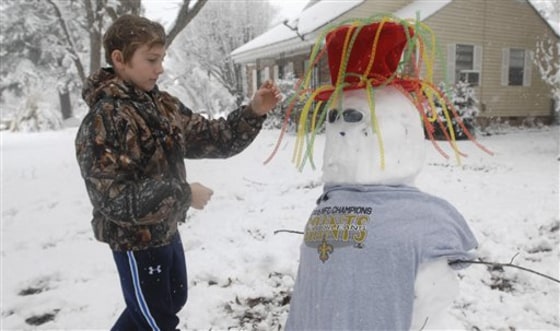 Kevin Skinner, 13, of Crystal Springs, Miss., says the snowman he built Friday is the mascot for the New Orleans Saints.